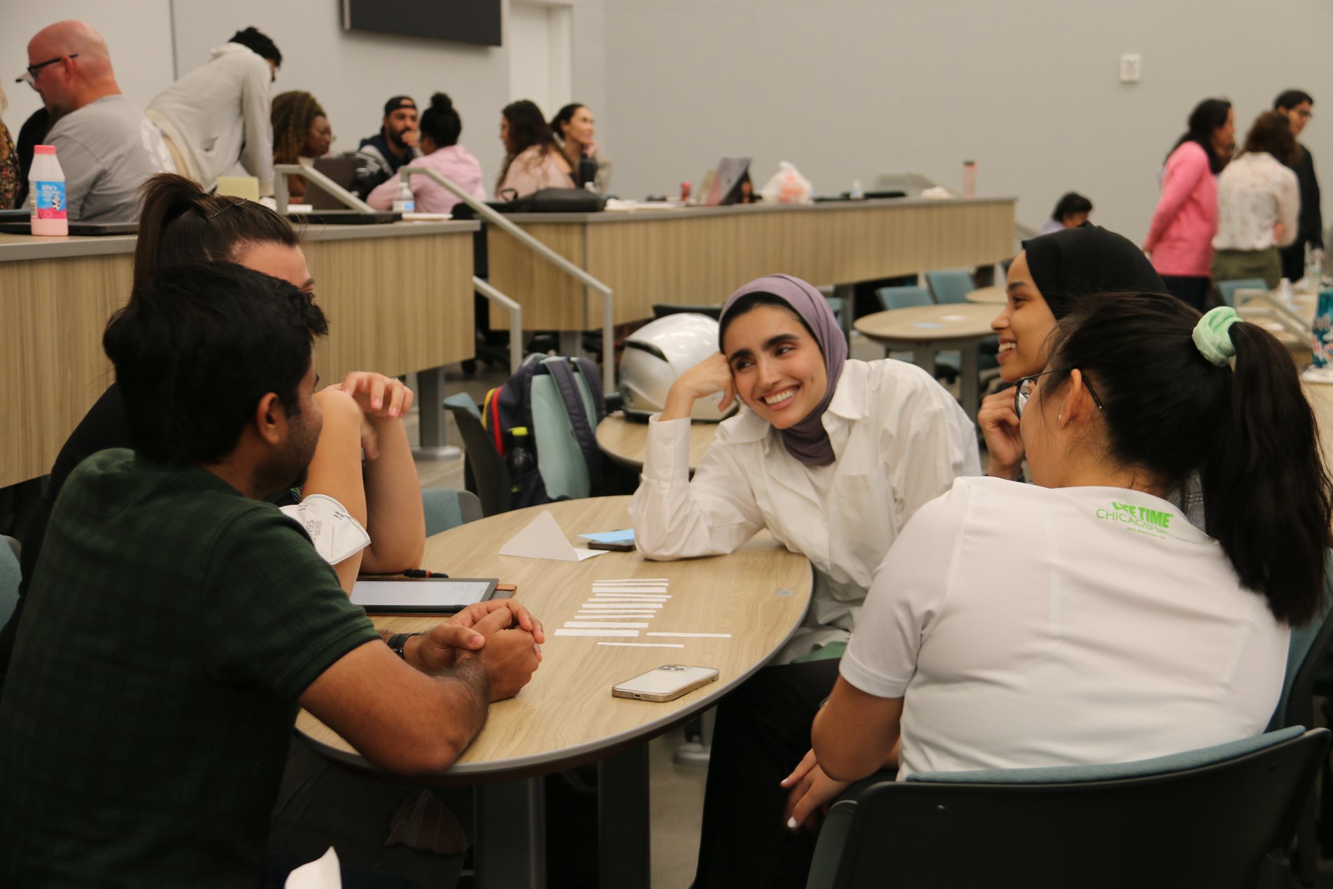A group of students sit together at a table.